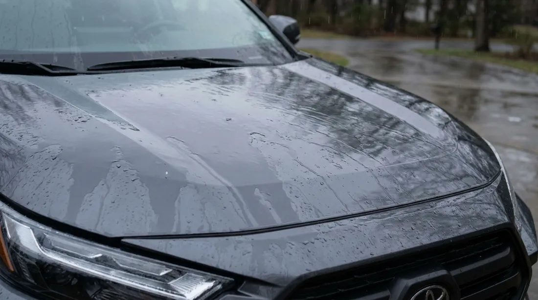 Before ceramic coating — rain sheets flat across the paint
