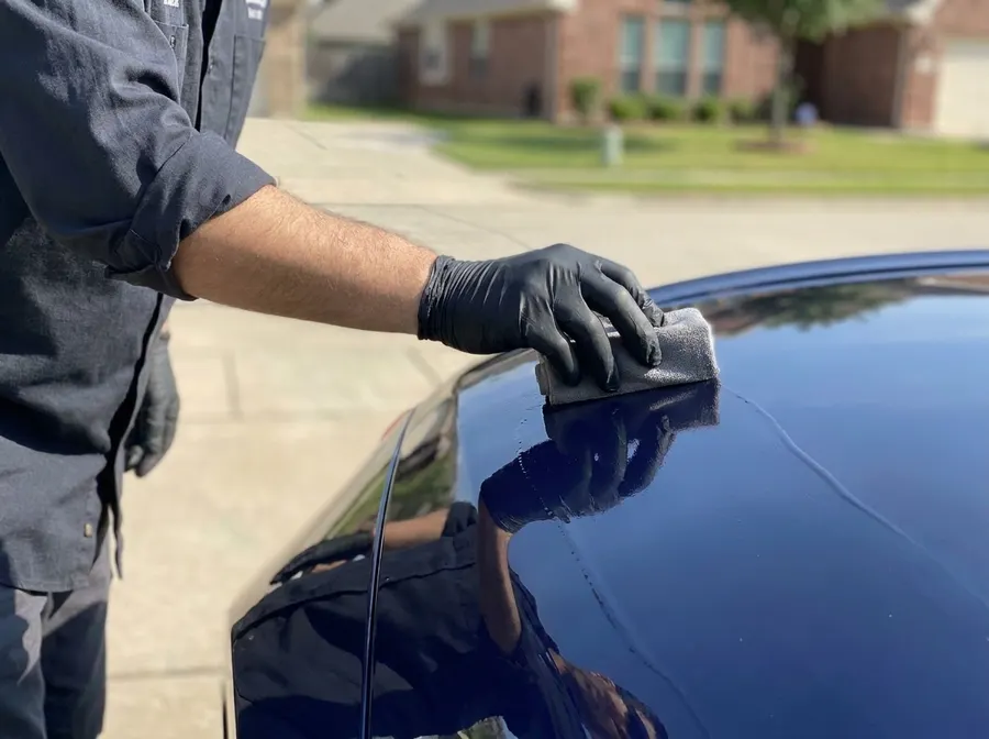 Applying ceramic coating by hand in a customer's driveway