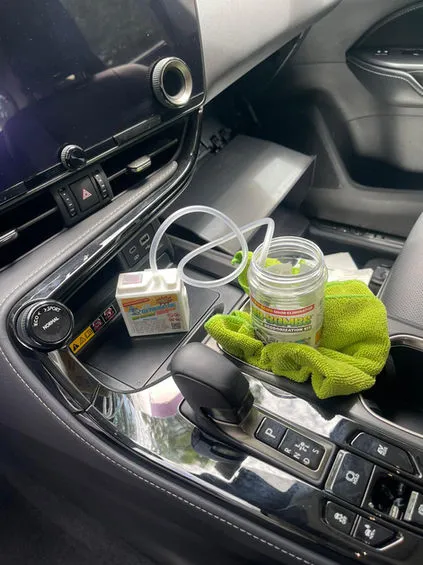 Engine bay cleaning products in use during a detail in Bristol, CT