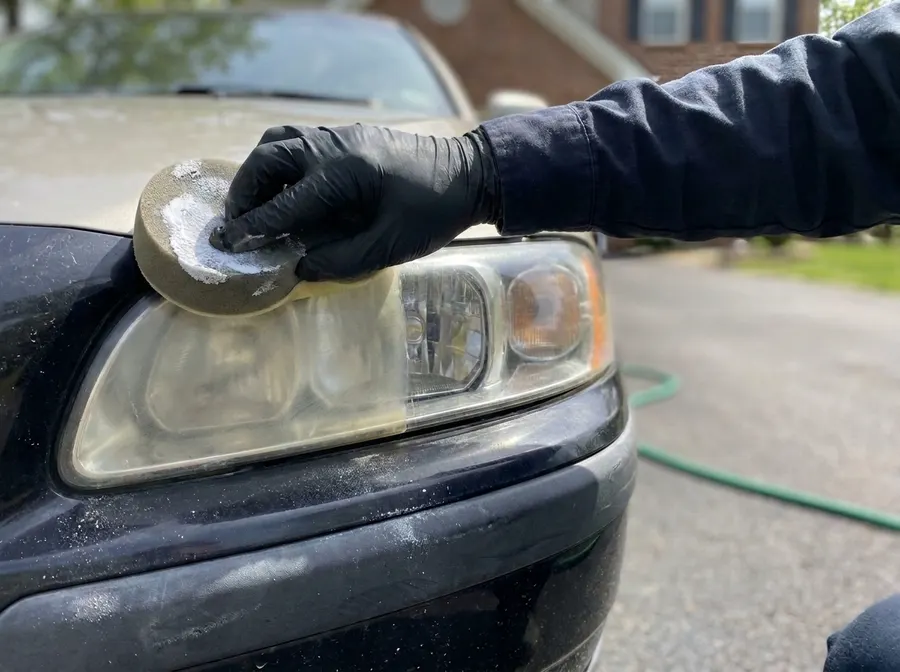 Polishing a yellowed headlight during restoration