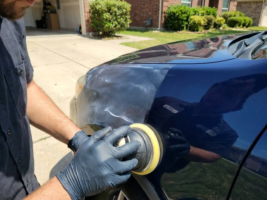 Machine-polishing a fender during paint correction